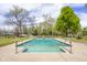 Bright in-ground swimming pool with safety handrails and surrounding greenery at 1840 W 100 N, Columbus, IN 47201