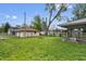 View of backyard featuring detached garage and lush green grass at 1953 N Alton Ave, Indianapolis, IN 46222