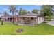View of backyard with covered patio and detached garage at 1953 N Alton Ave, Indianapolis, IN 46222