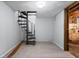Finished basement area featuring a spiral staircase and light wood flooring at 1953 N Alton Ave, Indianapolis, IN 46222