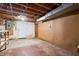 Unfinished basement featuring exposed ceiling beams and concrete floor at 1953 N Alton Ave, Indianapolis, IN 46222