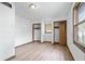 Bright bedroom with hardwood floors, two closets, and a window offering natural light and backyard views at 1953 N Alton Ave, Indianapolis, IN 46222