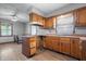 Spacious kitchen with wooden cabinets and updated flooring, ideal for cooking and entertaining at 1953 N Alton Ave, Indianapolis, IN 46222