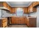 The kitchen is equipped with wooden cabinets, ample countertop space, and a view of the backyard at 1953 N Alton Ave, Indianapolis, IN 46222