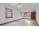 Bright living room with hardwood floors, two ceiling fans, and large windows providing natural light at 1953 N Alton Ave, Indianapolis, IN 46222
