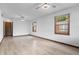 Large living room featuring hardwood floors, two ceiling fans, and large windows providing natural light at 1953 N Alton Ave, Indianapolis, IN 46222