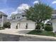 Three-car garage in a well-maintained building with brick accents and mature landscaping at 20776 Waterscape Way, Noblesville, IN 46062