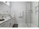 Bright bathroom featuring a glass shower, tiled floors, a double sink vanity and modern fixtures at 2226 Central Ave, Indianapolis, IN 46205