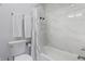 Modern bathroom with soaking tub and tiled shower with toiletries on shelves at 2226 Central Ave, Indianapolis, IN 46205