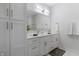 Bright bathroom with a double sink vanity, tiled floors and a modern lighting fixture at 2226 Central Ave, Indianapolis, IN 46205