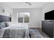 Bright bedroom features a large window, ceiling fan and modern dresser at 2226 Central Ave, Indianapolis, IN 46205