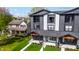 Modern townhouse with black and white siding, orange beam accents, landscaping, covered front porch, and second-story balconies at 2226 Central Ave, Indianapolis, IN 46205