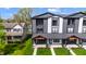 Modern townhouses with black and white siding, covered front porch, second-story balconies, and professionally landscaped lawns at 2226 Central Ave, Indianapolis, IN 46205