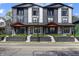 Modern townhome showcasing gray and white exterior, small balconies, and well-maintained front yard at 2226 Central Ave, Indianapolis, IN 46205