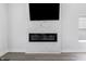 Contemporary fireplace set within a sleek marble wall with a mounted television above at 2226 Central Ave, Indianapolis, IN 46205
