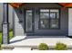 Charming front porch featuring sleek black door, window, and stone column accents at 2226 Central Ave, Indianapolis, IN 46205