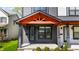 Inviting front porch with stylish entrance featuring an orange gable roof and dark gray siding at 2226 Central Ave, Indianapolis, IN 46205