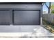 Double-wide garage with dark painted door, smooth concrete floor, and exterior light fixture at 2226 Central Ave, Indianapolis, IN 46205