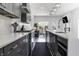 Modern kitchen with gray cabinets, quartz countertops, and stainless steel appliances looking into a living room at 2226 Central Ave, Indianapolis, IN 46205
