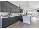 Spacious kitchen with gray cabinets, quartz countertops, stainless steel appliances, and views to dining and living areas at 2226 Central Ave, Indianapolis, IN 46205
