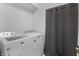 Functional laundry room featuring a washer, dryer and a gray privacy curtain at 2226 Central Ave, Indianapolis, IN 46205