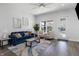 Bright living room with a comfortable blue sofa, neutral chairs, and lots of natural light at 2226 Central Ave, Indianapolis, IN 46205