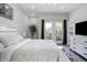 Spacious main bedroom featuring a ceiling fan, hardwood floors, and balcony access through double doors at 2226 Central Ave, Indianapolis, IN 46205