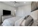 Modern main bedroom with a flat screen television, ceiling fan, and ensuite bathroom at 2226 Central Ave, Indianapolis, IN 46205