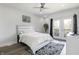 Sunlit main bedroom featuring a ceiling fan, hardwood floors, and balcony access through double doors at 2226 Central Ave, Indianapolis, IN 46205