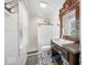 Bathroom featuring decorative tile floor, updated shower, and classic vanity with vintage mirror at 223 Haldale Dr, Carmel, IN 46032