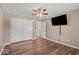 Bedroom featuring wood-look flooring, neutral paint, ceiling fan, and tv at 223 Haldale Dr, Carmel, IN 46032