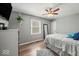 Comfortable bedroom featuring hardwood floors and natural light with large window views at 223 Haldale Dr, Carmel, IN 46032