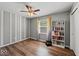 Bedroom featuring wood-look flooring, neutral paint, ceiling fan, and bookshelf at 223 Haldale Dr, Carmel, IN 46032