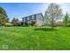 Landscaped yard with vibrant plants and trees highlighting this home's curb appeal at 223 Haldale Dr, Carmel, IN 46032
