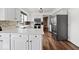 Spacious, modern kitchen with white cabinets, countertops, stainless appliances and beautiful backsplash at 223 Haldale Dr, Carmel, IN 46032