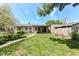 Cozy home featuring a well-maintained lawn, covered patio and privacy fence at 251 S 12Th Ave, Beech Grove, IN 46107