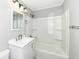 Bathroom featuring a shower-tub combination, vanity with drawers, a large mirror and modern fixtures at 251 S 12Th Ave, Beech Grove, IN 46107