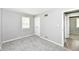 A secondary bedroom with neutral walls, carpet flooring, closet and a view to another space at 251 S 12Th Ave, Beech Grove, IN 46107
