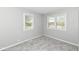 This bedroom has neutral walls and plush carpet with bright windows at 251 S 12Th Ave, Beech Grove, IN 46107