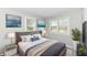 A cozy bedroom with a queen-size bed, bright windows and stylish decor at 251 S 12Th Ave, Beech Grove, IN 46107