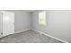 Neutral bedroom featuring gray walls, plush carpet, and natural light from a window at 251 S 12Th Ave, Beech Grove, IN 46107