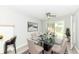 View of dining room featuring a glass table, neutral walls, ceiling fan, and sliding glass doors at 251 S 12Th Ave, Beech Grove, IN 46107