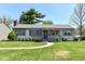 Charming single-story home features a well-manicured lawn and inviting walkway at 251 S 12Th Ave, Beech Grove, IN 46107
