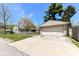 Detached two car garage with large parking pad and partial view of home at 251 S 12Th Ave, Beech Grove, IN 46107