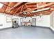 Two car garage with painted floor, refrigerator, shelving and workbench at 251 S 12Th Ave, Beech Grove, IN 46107