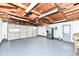 Spacious two car garage with painted floor, refrigerator and workbench at 251 S 12Th Ave, Beech Grove, IN 46107