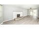View of living room with hardwood floors, fireplace, neutral walls, ceiling fan and natural light at 251 S 12Th Ave, Beech Grove, IN 46107