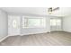 Bright, minimalist living room offers neutral walls, modern flooring and lots of sunlight at 251 S 12Th Ave, Beech Grove, IN 46107