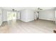 Large living room with hardwood floors, neutral walls, ceiling fans, and sliding doors to the yard at 251 S 12Th Ave, Beech Grove, IN 46107