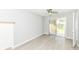 View of a room with hardwood floors, neutral walls, ceiling fan, and sliding glass doors at 251 S 12Th Ave, Beech Grove, IN 46107